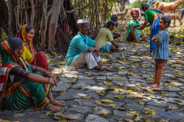 Kolhapur, India- March 16th 2019; Statue of Indian villagers wearing traditions and simple cloths sitting under tree and enjoying lunch and spending time with family members, at Kanheri math museum.